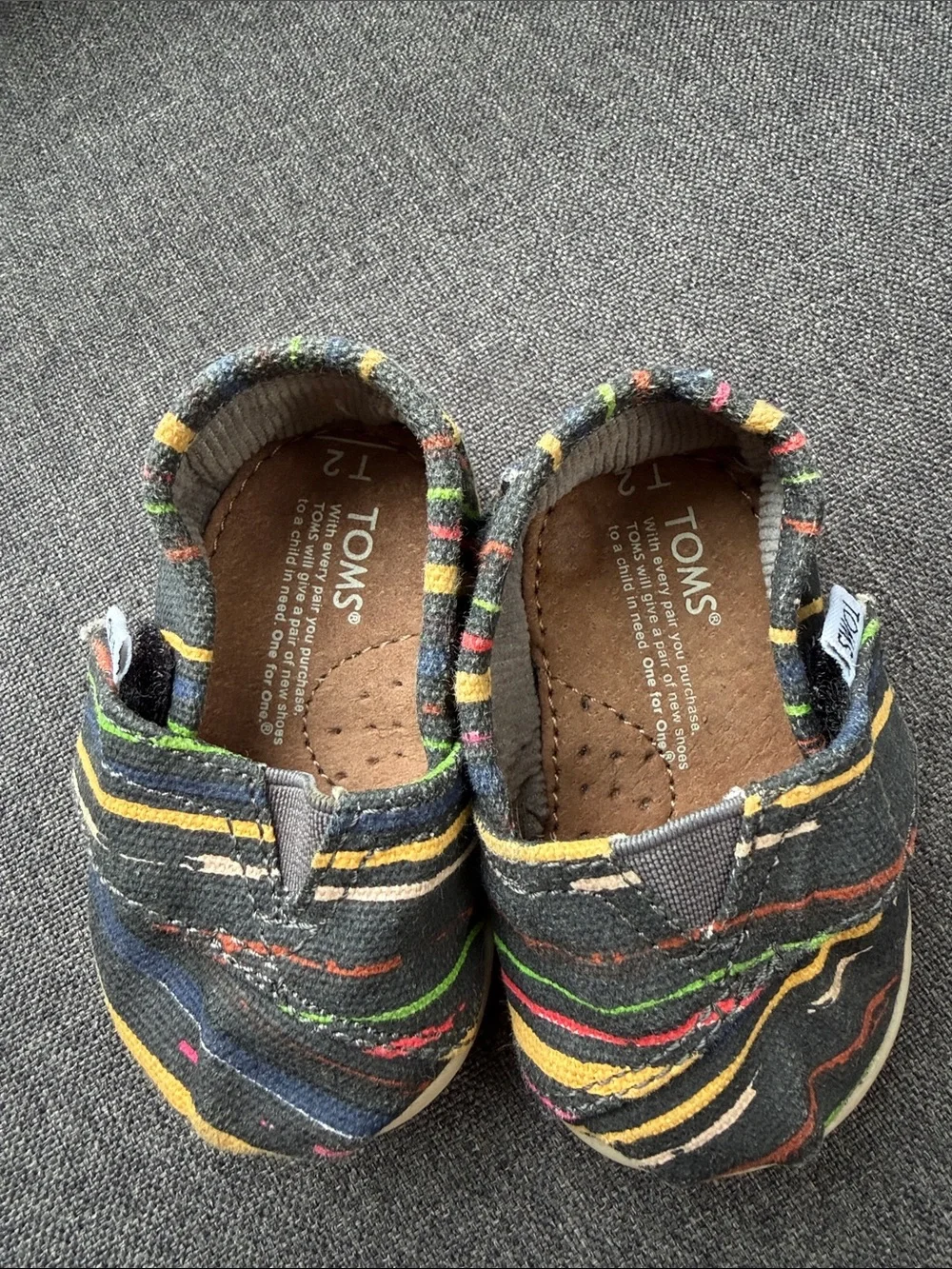 TOMS Baby Slip-On Shoes in Black with Multicolor Stripes